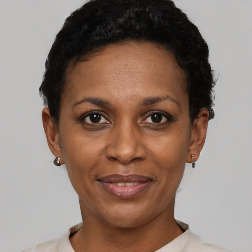 Joyful latino adult female with short  black hair and brown eyes