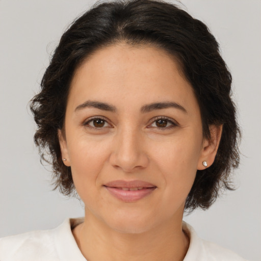 Joyful white young-adult female with medium  brown hair and brown eyes