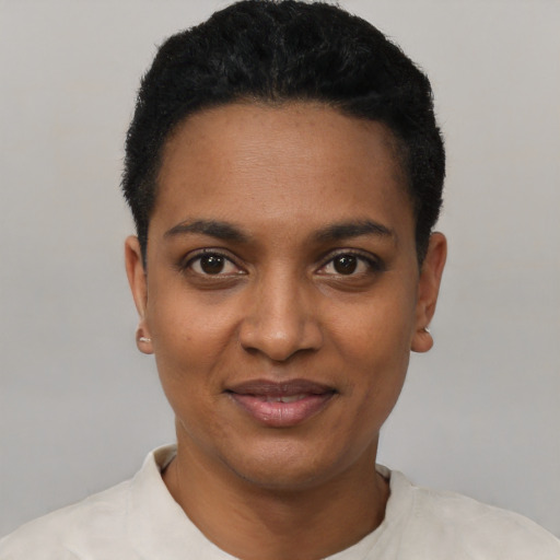 Joyful black young-adult female with short  black hair and brown eyes