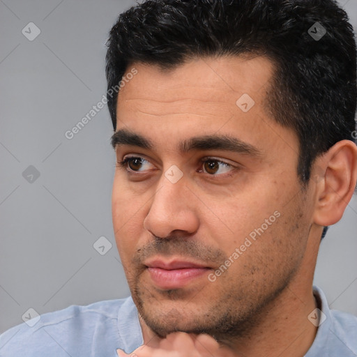 Joyful white young-adult male with short  black hair and brown eyes