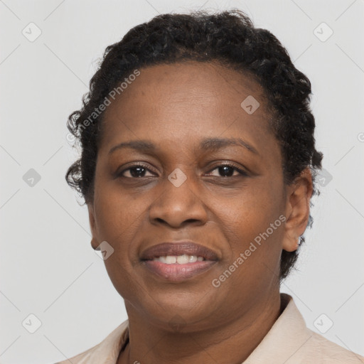 Joyful black adult female with short  brown hair and brown eyes