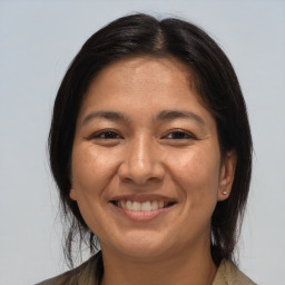 Joyful white adult female with medium  brown hair and brown eyes