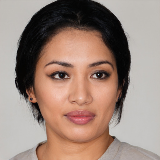 Joyful latino young-adult female with medium  black hair and brown eyes