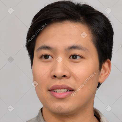 Joyful asian young-adult male with short  brown hair and brown eyes