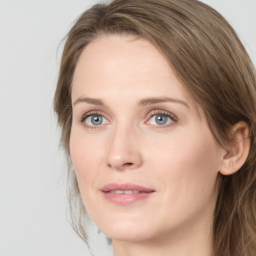 Joyful white young-adult female with long  brown hair and green eyes