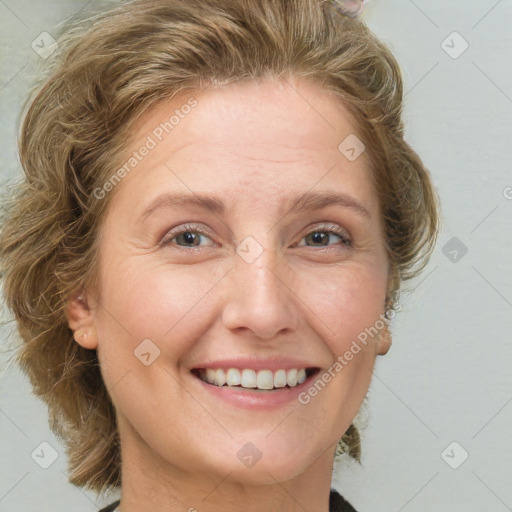 Joyful white adult female with medium  brown hair and green eyes