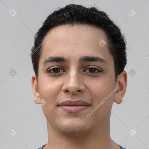 Joyful latino young-adult male with short  brown hair and brown eyes