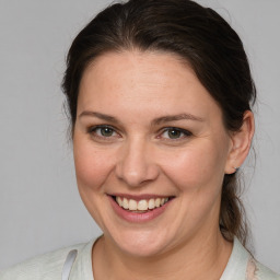 Joyful white adult female with medium  brown hair and blue eyes