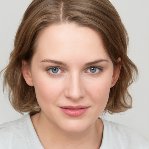 Joyful white young-adult female with medium  brown hair and blue eyes