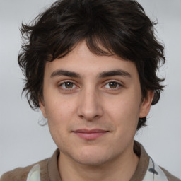 Joyful white young-adult male with medium  brown hair and brown eyes