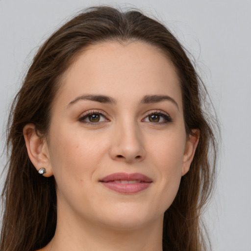 Joyful white young-adult female with long  brown hair and grey eyes