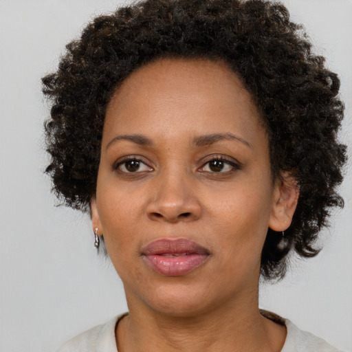Joyful black adult female with short  brown hair and brown eyes
