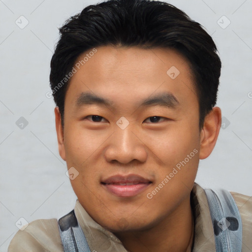 Joyful asian young-adult male with short  black hair and brown eyes