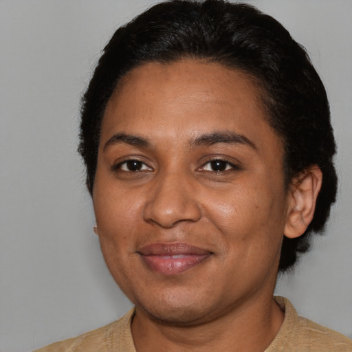 Joyful black adult female with short  brown hair and brown eyes