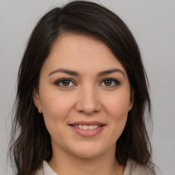 Joyful white young-adult female with medium  brown hair and brown eyes