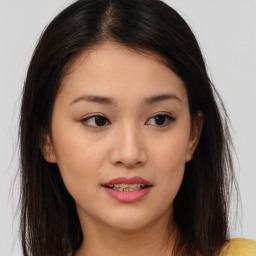 Joyful asian young-adult female with long  brown hair and brown eyes