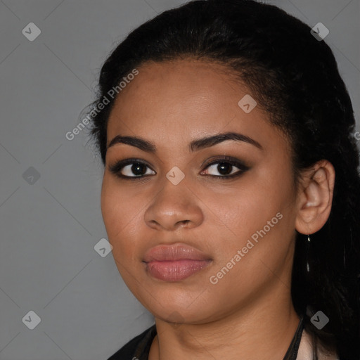 Joyful black young-adult female with long  black hair and brown eyes