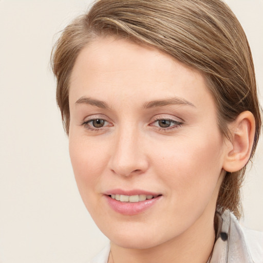 Joyful white young-adult female with medium  brown hair and blue eyes