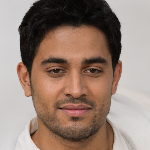 Joyful asian young-adult male with short  brown hair and brown eyes