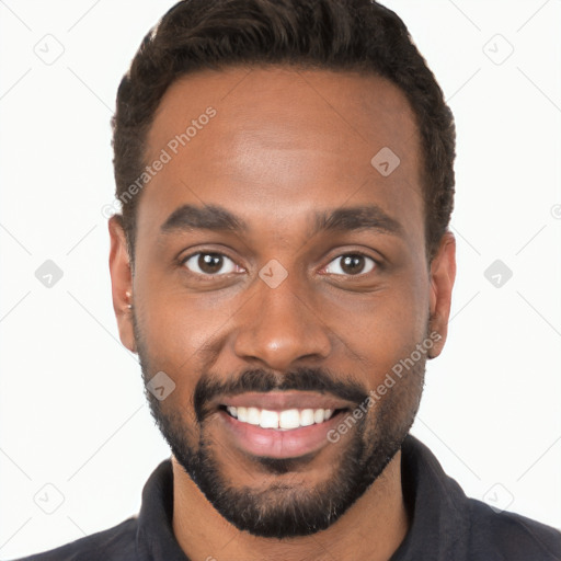 Joyful black young-adult male with short  black hair and brown eyes