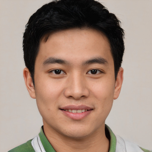 Joyful white young-adult male with short  black hair and brown eyes