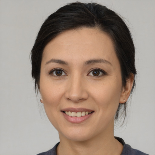 Joyful asian young-adult female with medium  brown hair and brown eyes