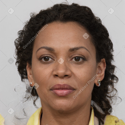 Joyful black adult female with medium  brown hair and brown eyes