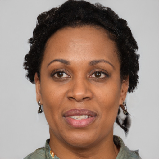 Joyful black adult female with short  brown hair and brown eyes