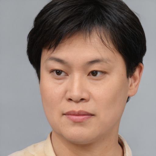 Joyful asian young-adult female with short  brown hair and brown eyes