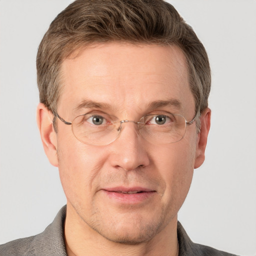 Joyful white adult male with short  brown hair and grey eyes