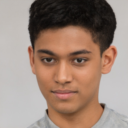 Joyful latino child male with short  brown hair and brown eyes