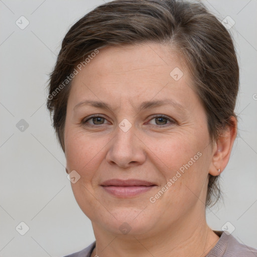 Joyful white adult female with short  brown hair and grey eyes