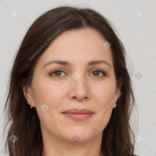 Joyful white adult female with long  brown hair and brown eyes