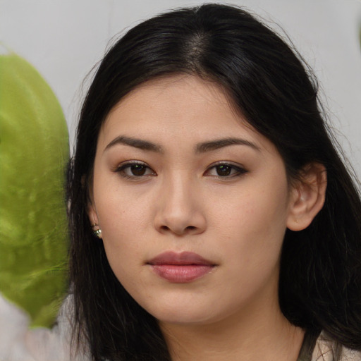 Joyful asian young-adult female with long  brown hair and brown eyes