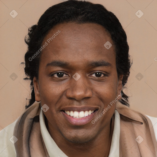 Joyful black young-adult male with short  brown hair and brown eyes