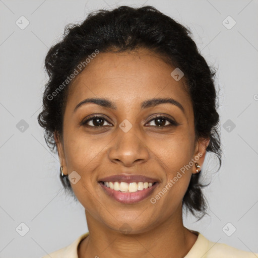 Joyful black young-adult female with long  brown hair and brown eyes