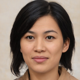 Joyful asian young-adult female with medium  black hair and brown eyes