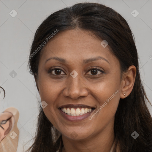 Joyful white adult female with long  brown hair and brown eyes