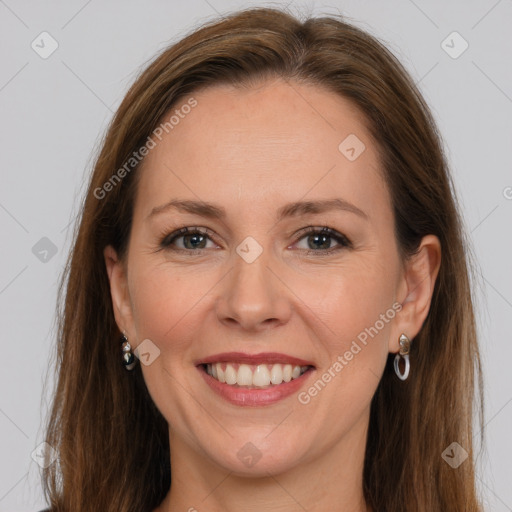 Joyful white adult female with long  brown hair and grey eyes