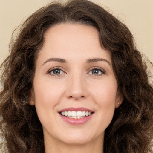 Joyful white young-adult female with long  brown hair and green eyes