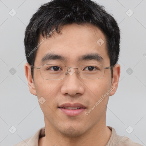 Joyful asian young-adult male with short  brown hair and brown eyes