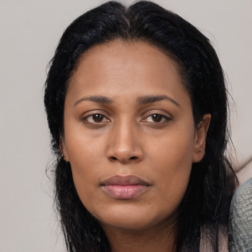 Joyful latino young-adult female with long  black hair and brown eyes