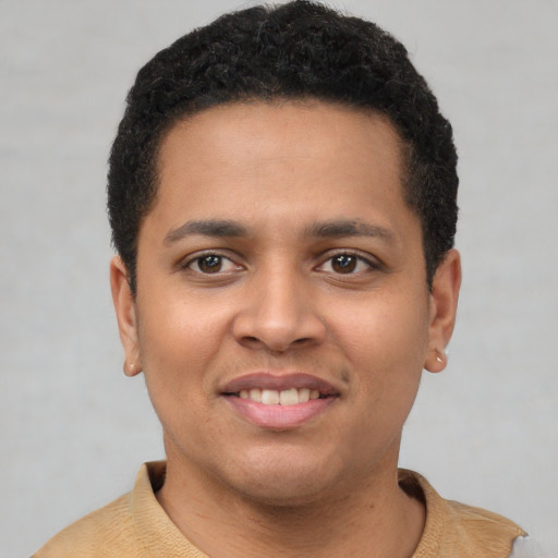 Joyful latino young-adult male with short  brown hair and brown eyes