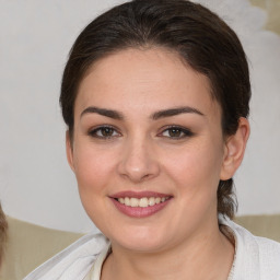 Joyful white young-adult female with medium  brown hair and brown eyes