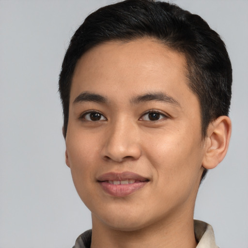 Joyful latino young-adult male with short  black hair and brown eyes