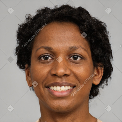 Joyful black adult female with short  brown hair and brown eyes