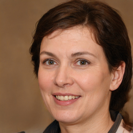 Joyful white adult female with medium  brown hair and brown eyes