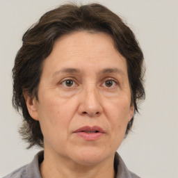 Joyful white middle-aged female with medium  brown hair and brown eyes