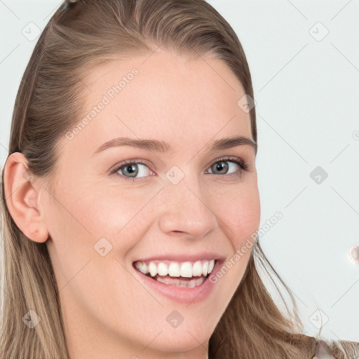 Joyful white young-adult female with long  brown hair and blue eyes