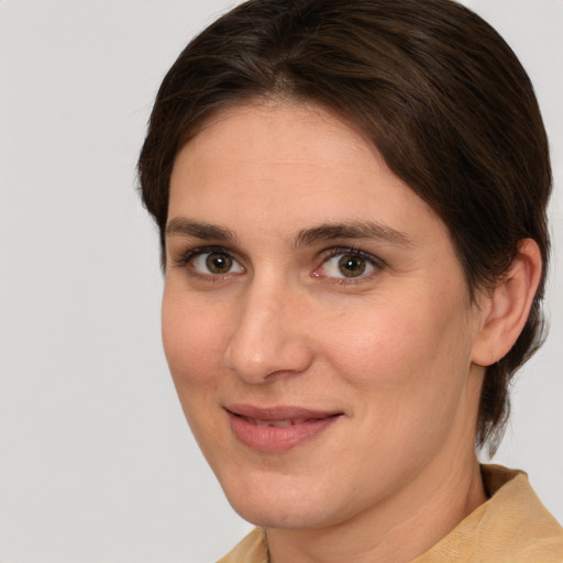 Joyful white young-adult female with medium  brown hair and brown eyes